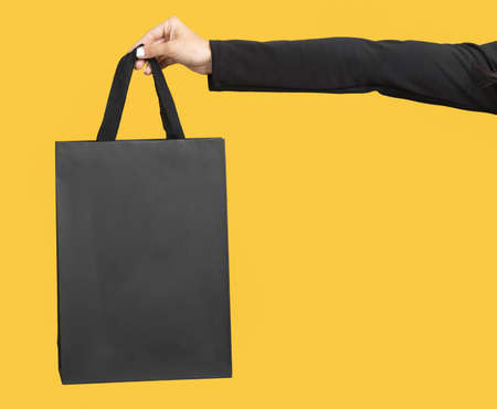 person holding big black shopping bag copy space. Resolution and high quality beautiful photoの写真素材