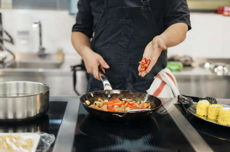male chef adding chili dish. Resolution and high quality beautiful photoの写真素材