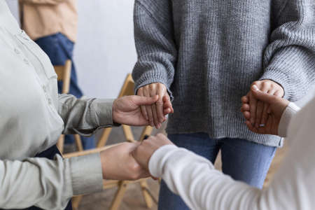 people holding hands group therapy session. Resolution and high quality beautiful photoの写真素材