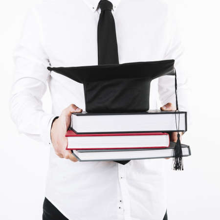 man holding books mortarboard. Resolution and high quality beautiful photoの写真素材