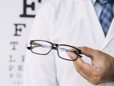 male doctor holding pair eyeglasses his hands. Resolution and high quality beautiful photoの写真素材