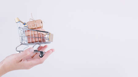 person holding small grocery cart with gift boxes. Resolution and high quality beautiful photoの写真素材
