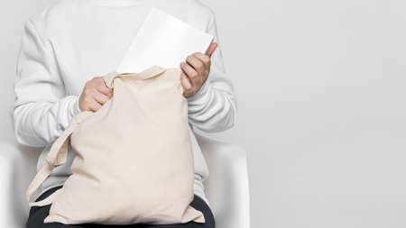 front view woman holding fabric tote bag. Resolution and high quality beautiful photoの写真素材