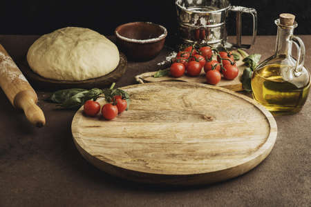 high angle of pizza dough with wooden board and tomatoes. Resolution and high quality beautiful photoの写真素材