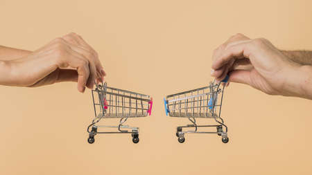 hands holding small shopping carts. Resolution and high quality beautiful photoの写真素材
