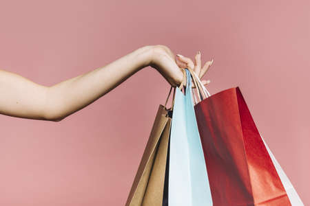 hand with colorful shopping bags. Resolution and high quality beautiful photoの写真素材