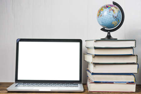 globe books near laptop. Resolution and high quality beautiful photoの写真素材