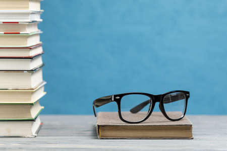front view pile books with glasses. Resolution and high quality beautiful photoの写真素材