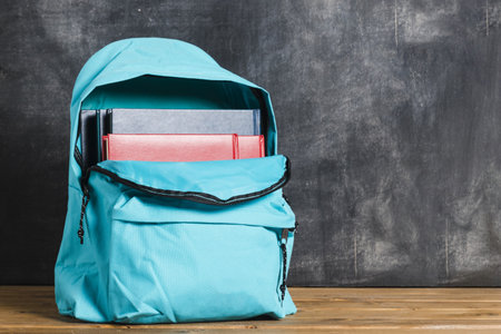 blue backpack with textbooks. Resolution and high quality beautiful photo
