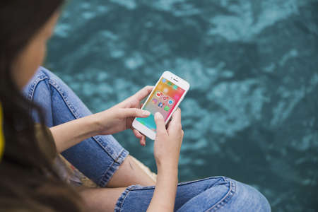 woman using cellphone with social media notifications screen. High quality beautiful photo conceptの写真素材