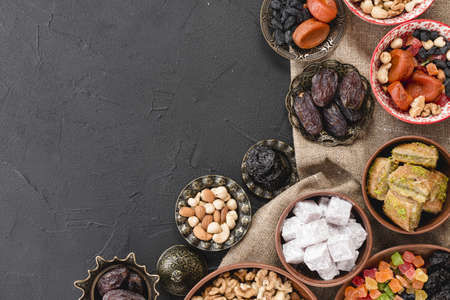 traditional ramadan dessert nuts metallic earthen bowl black backdrop. High quality beautiful photo conceptの写真素材