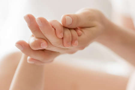 close up mom holding baby s hand. High quality beautiful photo conceptの写真素材