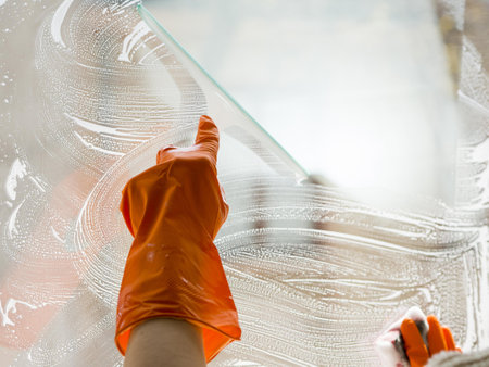 close up hand with rubber glove cleaning window. High quality beautiful photo concept