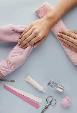 close up manicurist holding customer hand. High quality beautiful photo conceptの写真素材