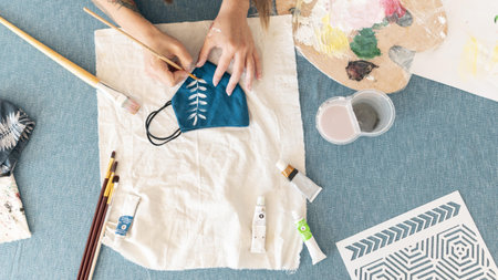 close up hands painting on mask top view.の写真素材