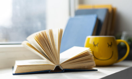 Photo Open book and smiley cup. High quality beautiful photo conceptの写真素材