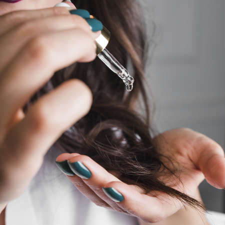 brunette hair with serum. High quality beautiful photo concept