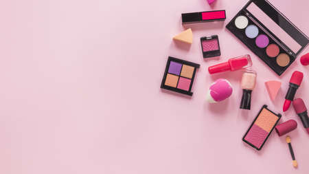 different cosmetics types scattered pink table. High quality beautiful photo conceptの写真素材