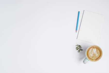 blank paper blue colored pencil cup cappuccino coffee white background. High quality beautiful photo...