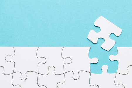 missing puzzle piece with white puzzle grid blue background. High quality beautiful photo concept