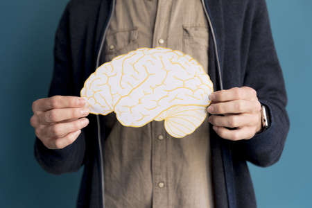 close up man holding paper brain. High quality beautiful photo conceptの写真素材