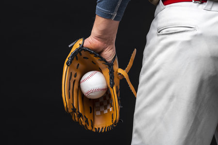 back view man holding glove with baseball. High quality beautiful photo conceptの写真素材