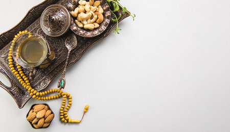 tea glass with nuts, beads on tray.の写真素材