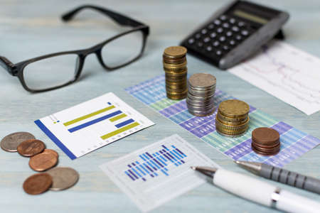 reading glasses piles coins high view. High quality beautiful photo conceptの写真素材