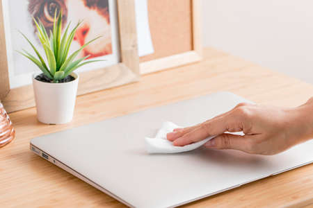 high angle hand disinfecting laptop desk