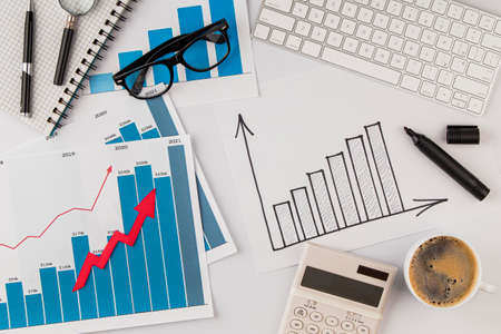 top view office desk with growth chart glasses. High quality photo