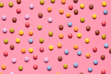 full frame colorful multicolored gem candies pink backgroundの写真素材