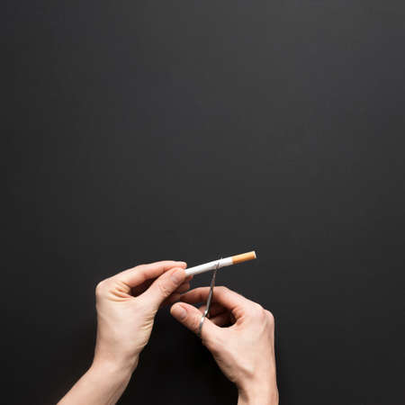 top view hand cutting cigaretteの写真素材