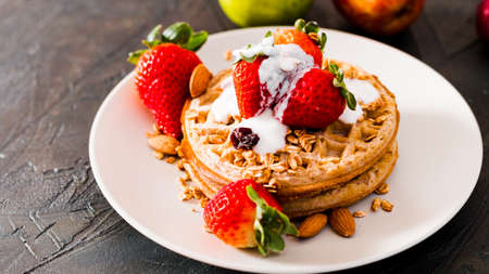 high angle waffles with strawberries yogurtの写真素材