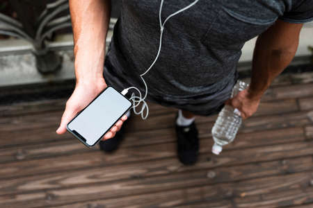 top man holding phone mock up. High quality photoの写真素材