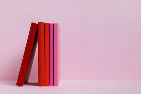 colorful books with pink background. High quality photoの写真素材