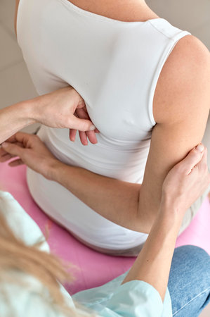 physiotherapist undergoing therapy with female patient. High quality photo