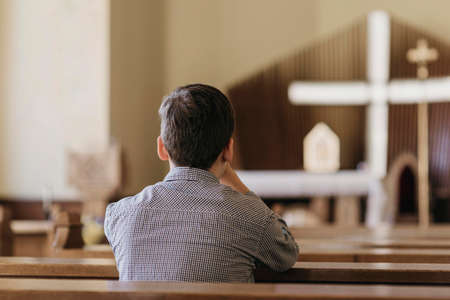 back view young boy praying church. High quality photoの写真素材