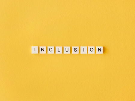 inclusion word written scrabble letters yellow background. High quality photoの写真素材