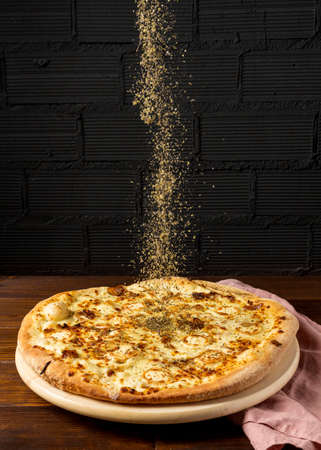 high angle dried herbs sprinkled pizza. High quality photoの写真素材