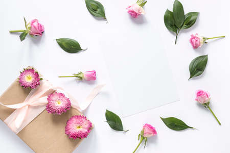 high angle view flowers leaves with gift box white surface. High quality photoの写真素材