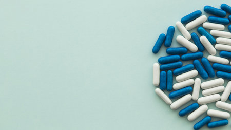 high angle view white blue candy capsules green background. High quality beautiful photo conceptの写真素材