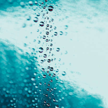 abstract water drops turquoise glass background. High quality photoの写真素材