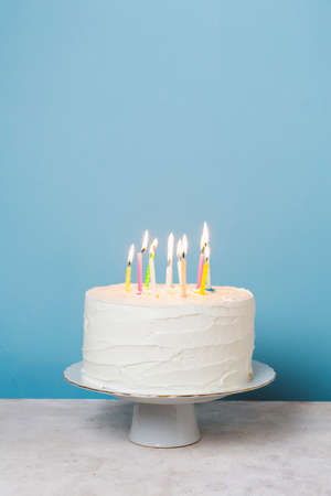 front view lit candles birthday cake. High quality photoの写真素材
