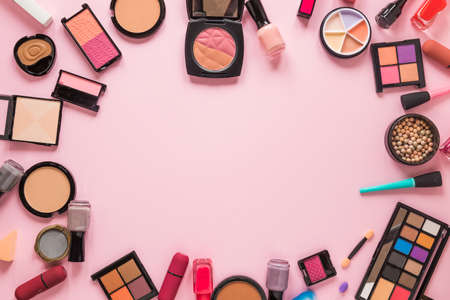 different cosmetics types scattered pink table. High quality photoの写真素材