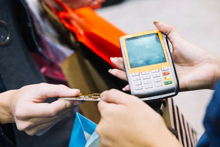 crop customer assistant with paying machine. High quality photo