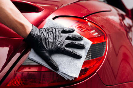 close up person cleaning car exterior. High quality photoの写真素材