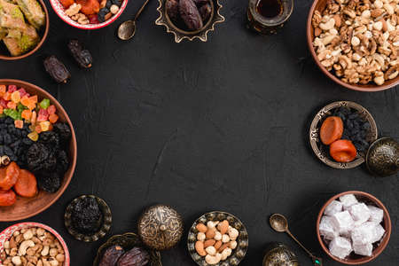 arabic delicious dried fruits nuts lukum baklava black backdrop. High quality photoの写真素材