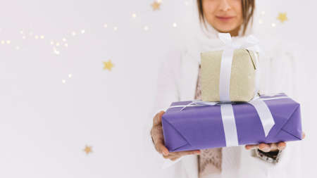 eid al fitr concept with muslim woman holding present boxes.の写真素材