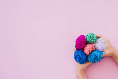 elevated view hand holding colorful wool pink background 2. High quality beautiful photo concept
