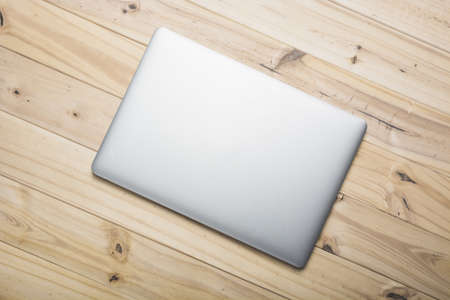 elevated view laptop on wooden plank.の写真素材